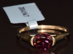 A 9k gold ring set with an oval cut Umba River garnet of approximately 1.4ct, with Gemporia