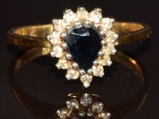 An 18ct gold ring set with a pear and sapphire surrounded by diamonds, 2.7g, size K/L