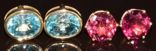 Two pairs of 9k gold earrings, one pair set with oval cut zircons and the other umbalite, with
