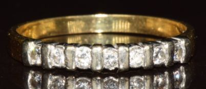 An 18ct gold ring set with seven round cut diamonds, 3.2g, size U