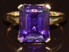 A 9k gold ring set with an octagonal cut Siberian amethyst of approximately 4.2ct and white