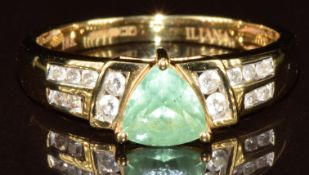 An 18k gold ring set with a trillion cut tourmaline and diamonds, 3.6g, size O