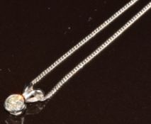 An 18ct white gold pendant set with a round brilliant cut diamond of approximately 0.4ct, on 18ct