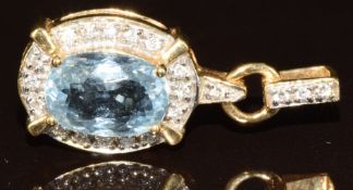 An 18k gold pendant set with an oval cut Paraiba tourmaline of approximately 2.7ct and round cut