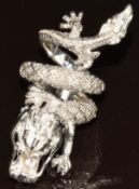 A silver ring in the form of a dragon set with blue diamond eyes and diamonds to the body, 19.6g,