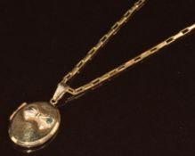 A 9ct gold locket with embossed bow decoration, on 9ct gold chain made up of rectangular links, 3.