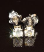 A pair of 18k white gold earrings each set with a round brilliant cut diamond of approximately 0.