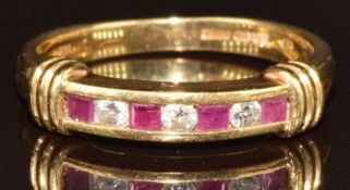 An 18ct gold ring set with calibre cut rubies and round cut diamonds, 4.2g, size P
