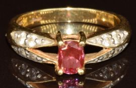 An 18ct gold ring set with an oval cut pink diamond of approximately 0.5ct with diamonds to the