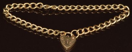 A 9ct gold curb link bracelet with heart padlock clasp, 9.4g, 20cm
