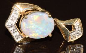 A 9k gold pendant set with a oval Lightning Ridge black opal and white sapphires, with