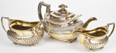Georgian hallmarked silver tea set with gadrooned rims, lobed lower bodies and raised on four ball