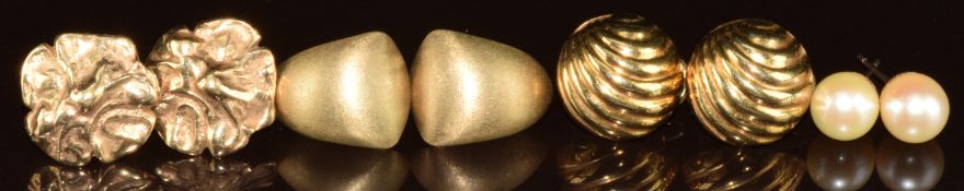 Three pairs of 9ct gold earrings including matt textured pair, floral pair and one pair with