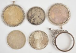 Five 1780 Maria Theresa Thaler silver coins, two in mounts, together with a further coin mount,