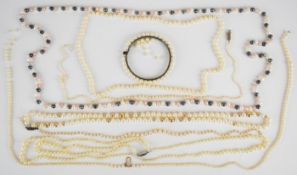 Four single strands of cultured pearls, another single strand of cultured pearls with gold bead