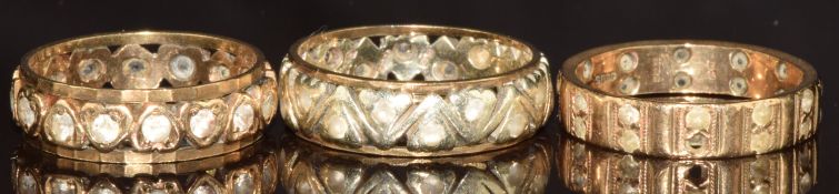 Three 9ct gold eternity rings, all set with spinel, 10.6g, size O & P