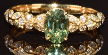 Kat Florence 18k gold ring set with an oval step cut Russian demantoid garnet of approximately 0.