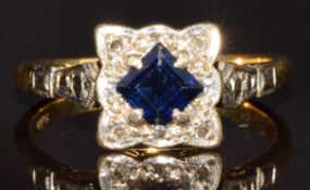 An 18ct gold ring set with a square cut sapphire and diamonds in a platinum mount, 4.1g, size O