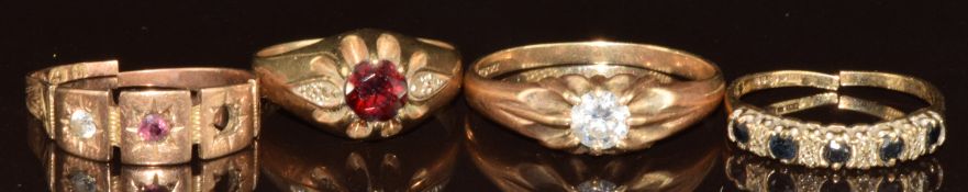 Four 9ct gold rings, one set with sapphires and diamonds, one set with a garnet, one set with a