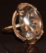 A 9ct gold ring set with an oval cut smoky quartz, 7.3g, size K