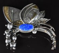 A silver brooch with applied 18k gold decoration and set with lapis lazuli, 60.2g, 8 x 10cm