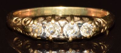 An 18ct gold ring set with four old cut diamonds, 2.7g, size N