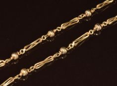 A 9ct gold necklace made up of twisted elongated links and ridged sphere beads, 19.5g, 58cm