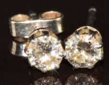 A pair of 9ct white gold earrings each set with a diamond of approximately 0.22ct, 1g