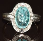 An 18k white gold ring set with an oval Paraiba tourmaline cabochon of approximately 3.2ct