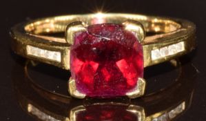 An 18k gold ring set with a garnet and diamonds, 4.5g, size N