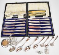 Hallmarked silver items comprising seven various spoons, three napkin rings, ARP badge, Baker's