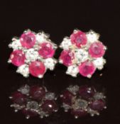 A pair of 9ct white gold earrings set with rubies and diamonds in a cluster, 2.3g
