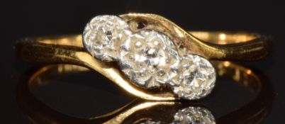 An 18ct gold ring set with three diamonds in a twist platinum setting, 1.9g, size K/L