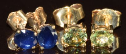 Two pairs of 9k gold earrings, one pair set with oval cut sapphires and the other pair Ambanja
