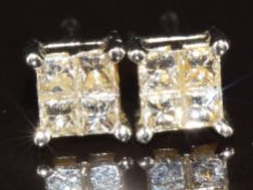 A pair of 18ct white gold earrings each set with four square cut diamonds, 1g