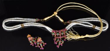 A double strand of cultured pearls with silver gilt pendant set with rubies and emeralds, with