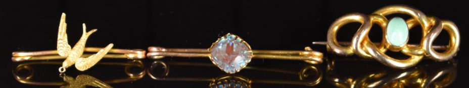 A 15ct gold swallow brooch (1.3g, 3cm), 9ct gold knot brooch set with turquoise (3.5g, 3cm),