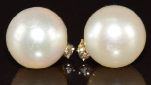 A pair of white gold earrings each set with a diamond and pearl, 2.3g