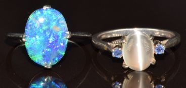 Two silver rings, one set with a moonstone cabochon and two sapphires and the other one an opal