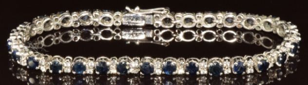 A white metal bracelet set with sapphires and quartz (tests as 9k white gold), 10.5g,17cm