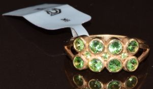 A 9k gold ring set with eleven round cut tsavorite garnets, total 0.87ct, with Gemporia certificate,