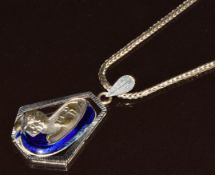 An 18kt white gold pendant in the form of the Madonna and child set with enamel, on 18k gold