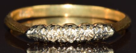 An 18ct gold ring set with three diamonds in a platinum setting, 1.5g, size M