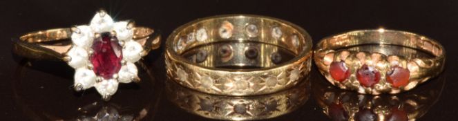 Three 9ct gold rings, one set with garnets, one a garnet and cubic zirconia and the other spinel,