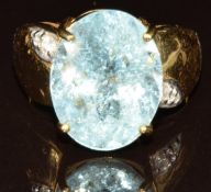An 18k gold ring set with an oval cut Paraiba tourmaline of approximately 9.2ct and diamonds, with