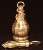 Two yellow metal charms, one in the form of a fist and the other a bottle, 4.2g