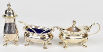 Modern hallmarked silver three piece cruet set comprising pepper, salt, mustard and two spoons,