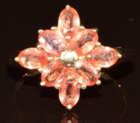 A 9k gold ring set with eight oval cut Padparadscha sapphires, the total carat weight