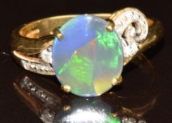 An 18k gold ring set with a Lightning Ridge black opal cabochon of approximately 1.2ct and diamonds,
