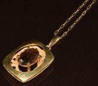 A 9ct gold pendant set with an oval cut smoky quartz (2.2 x 3cm), on 9ct gold fancy chain, 8.2g,